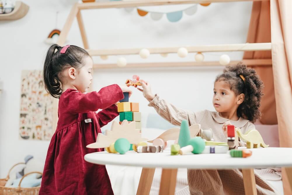 Two preschool girls playing blocks at a childcare center